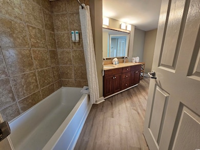 Bathroom featuring wood-type flooring, shower / tu