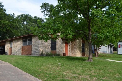 View of front of house featuring stone siding and