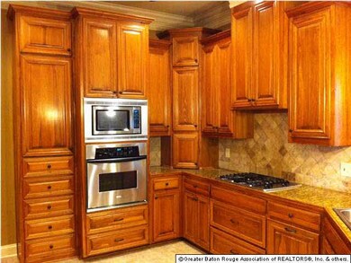 Cypress Cabinets with Stainless Microwave and Wall