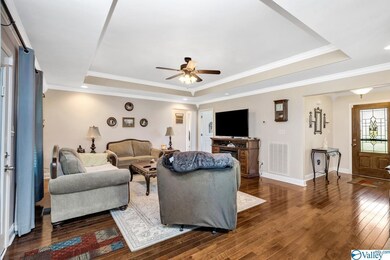 Featuring ceiling fan, crown molding, trey ceiling