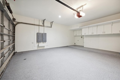 Garage with new epoxy floor with cabinets and laun