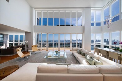 The stunning living room is the heart of the home — where sophisticated design meets effortless comfort. With expansive windows framing sweeping city views, this space invites relaxation, conversation, and unforgettable moments.