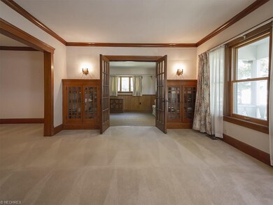 Formal living room with wide baseboards, crown mol