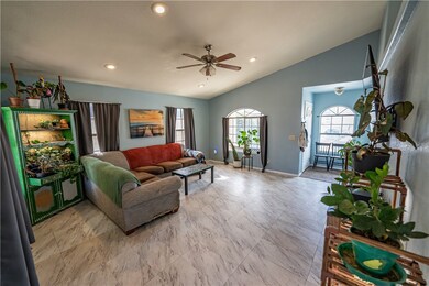 Living room with lofted ceiling and ceiling fan