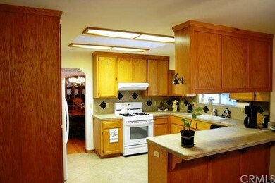 The large kitchen features abundant cabinetry, til
