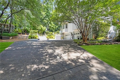 View of front of house featuring a garage, driveway, and a front yard