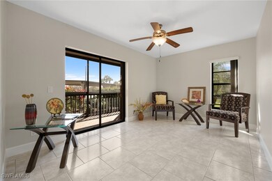 Living area featuring ceiling fan and light tile p