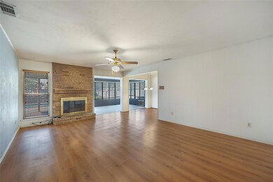 Unfurnished living room featuring a brick fireplac