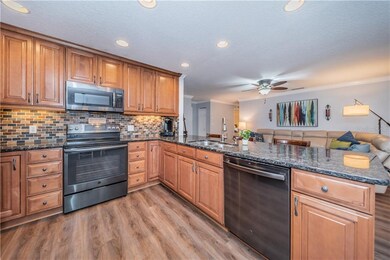 Spacious kitchen with new black stainless applianc