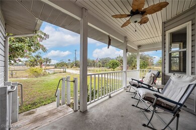 View of patio with ceiling fan and a porch