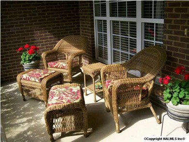 The covered front porch that overlooks the cul de sac with mountain views.