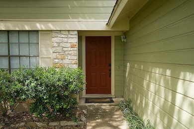 Property entrance featuring stone siding