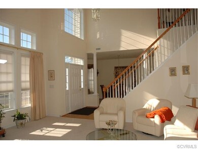 Two story foyer with wood laminate floor, chandeli