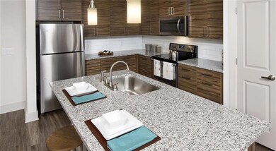 Kitchen with a kitchen bar, appliances with stainl