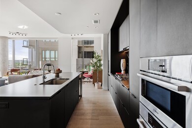 Kitchen featuring a sink, a kitchen island with s