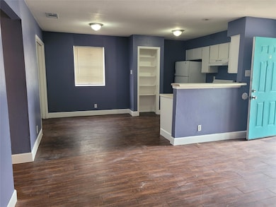 Kitchen featuring freestanding refrigerator, ligh