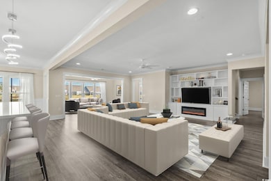 Living area with wood finished floors, recessed lighting, a glass covered fireplace, ceiling fan, and ornamental molding