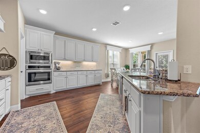 Kitchen featuring dark wood-type flooring, stainle