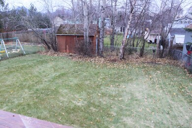 fenced back yard with a shed