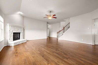 Unfurnished living room with stairs, hardwood / w