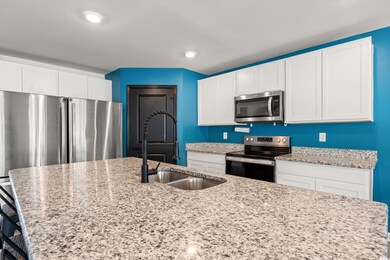 Kitchen featuring white cabinets, recessed lightin
