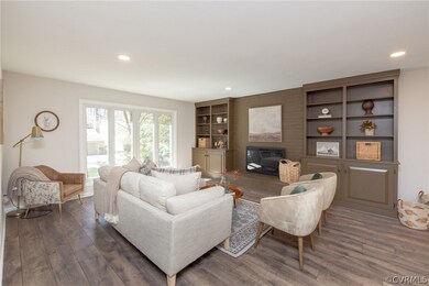 Living room featuring a fireplace, built in shelve