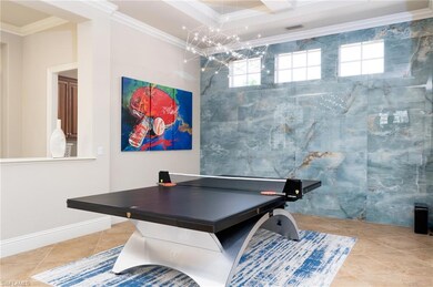 Game room with ornamental molding and tile patterned floors