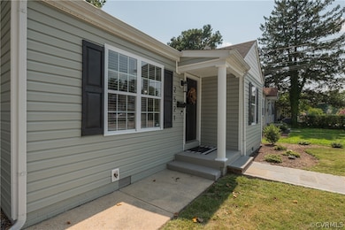 View of exterior entry featuring a lawn