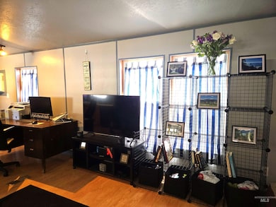 Office with wood finished floors and a textured ceiling