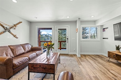 Living area with recessed lighting, light wood-typ