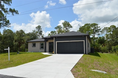 View of front facade with concrete driveway, an attached garage, a front lawn, and roof with shingles