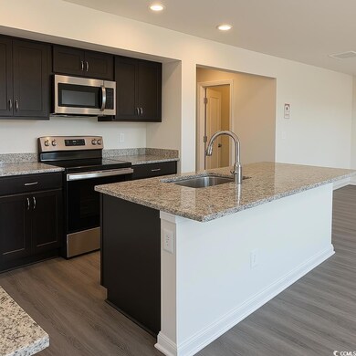 Kitchen featuring LVP flooring, recessed lighting, visible vents, stainless steel appliances, and a sink