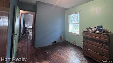 Bedroom featuring dark wood-style flooring