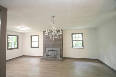 Unfurnished living room featuring a textured ceili