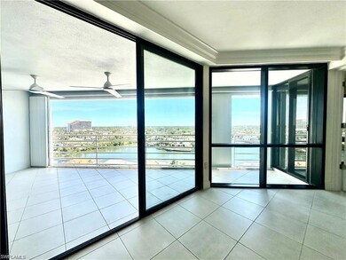 Doorway with a water view, a wall of windows, tile patterned floors, and ceiling fan