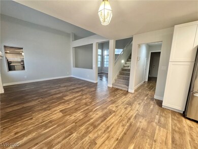 Spare room with stairway and wood finished floors