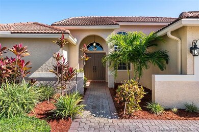 Covered entry with double doors into home.
