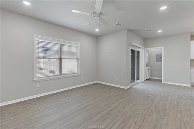Empty room with ceiling fan and light hardwood / w