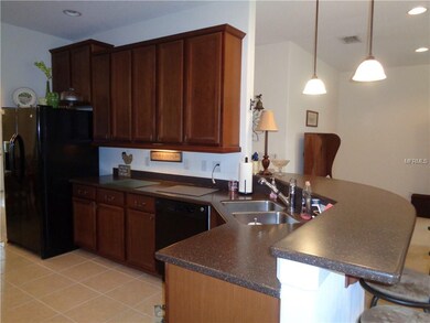 Solid surface counters and wood cabinets.