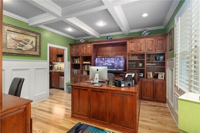 Enjoy working in this office with loads of built in cabinets and a crisp coffered ceiling