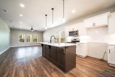 Kitchen featuring white cabinets, a center island 