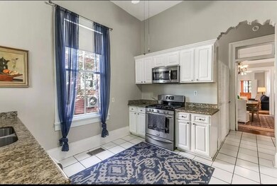 Kitchen has a custom arch, granite counters and st