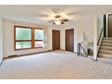 The living area has a large picture window, a ceil