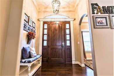 A large, welcoming Foyer and tall ceilings! The rich warm Wood flooring invites you in.