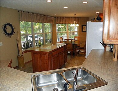 Window on the world~ Makes being in the kitchen fascinating! And, the Island bar has lots of storage underneath.