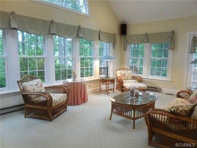 The vaulted Florida Room with newer windows has lo