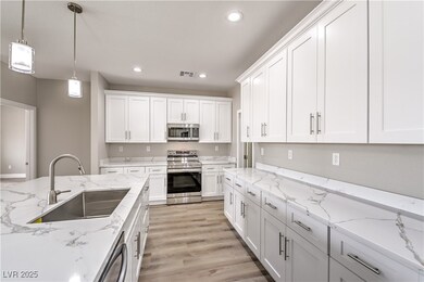 Kitchen with white cabinets, visible vents, stainl