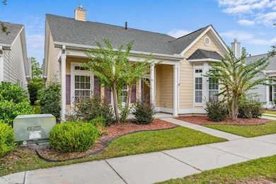 View of front of home featuring a chimney, a shingled roof, and a front yard