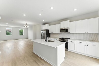 The kitchen offers loads of cabinets and counter space. Similar home shown. Color and finish may vary.