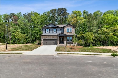 Craftsman-style house with driveway, stone siding,